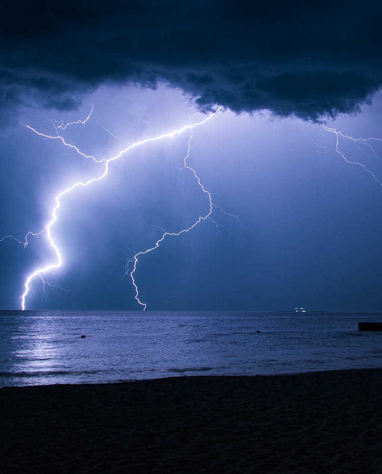 A View Of A Lightning Strike From The Beach 