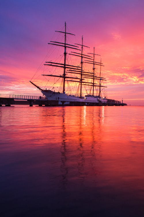 Silhouette of Ship on Sea during Sunset