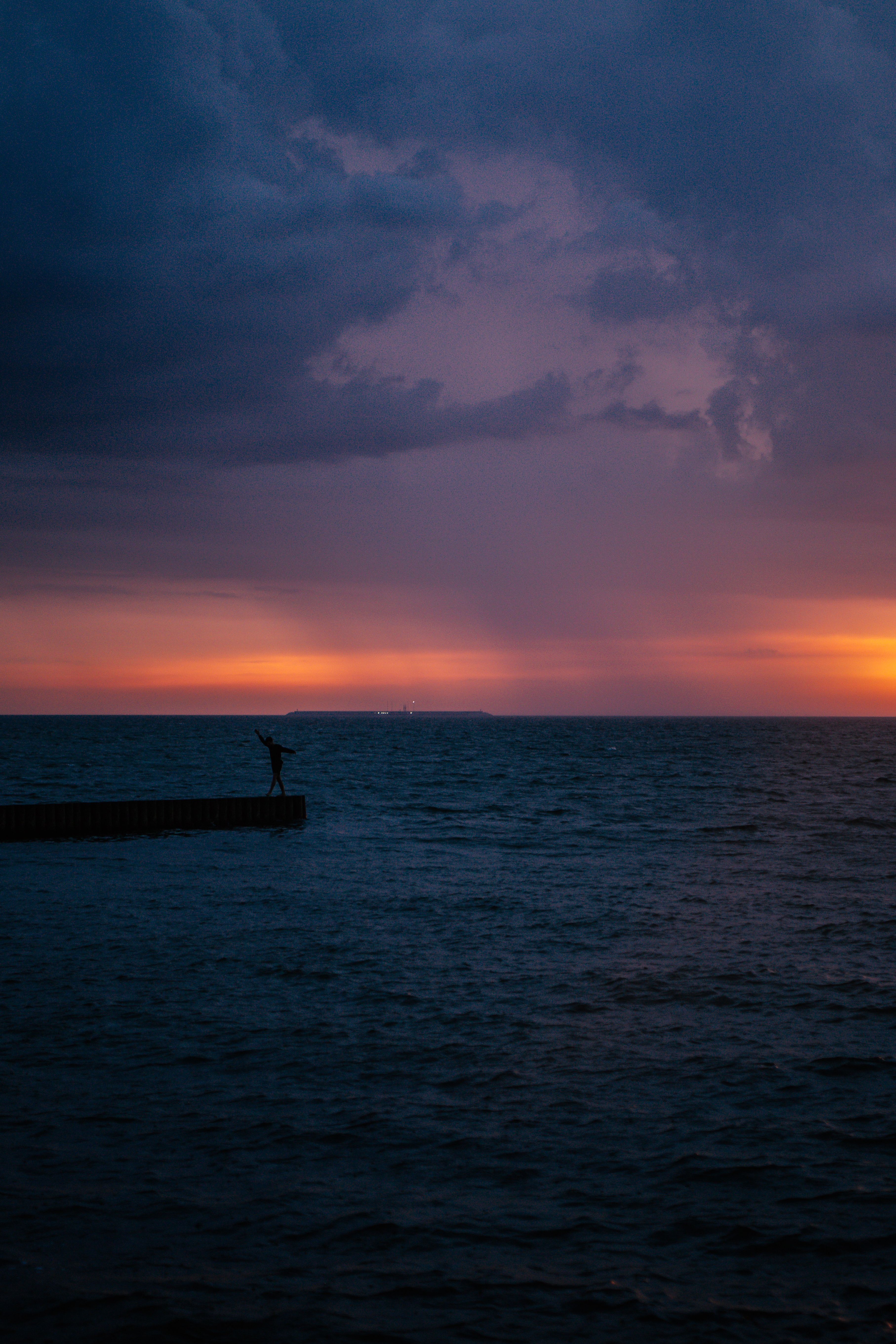 Silhouette of Person Standing on Dock during Sunset · Free Stock Photo