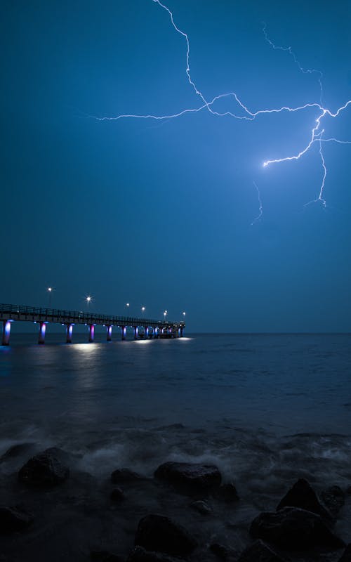 Free A Lightning Strike Across the Night Sky Stock Photo