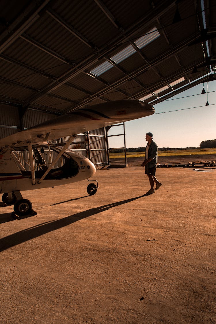 Man And Plane In Hangar