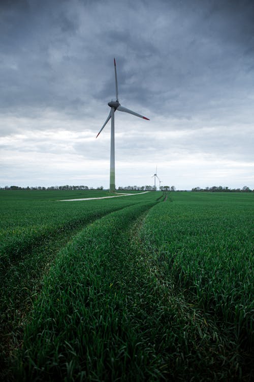 White Wind Turbines on Green Grass Field