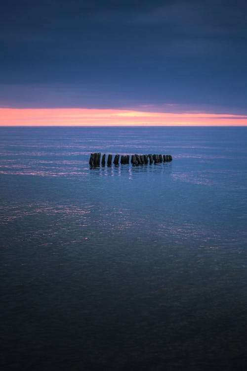 Free 
Wooden Posts in the Ocean Stock Photo