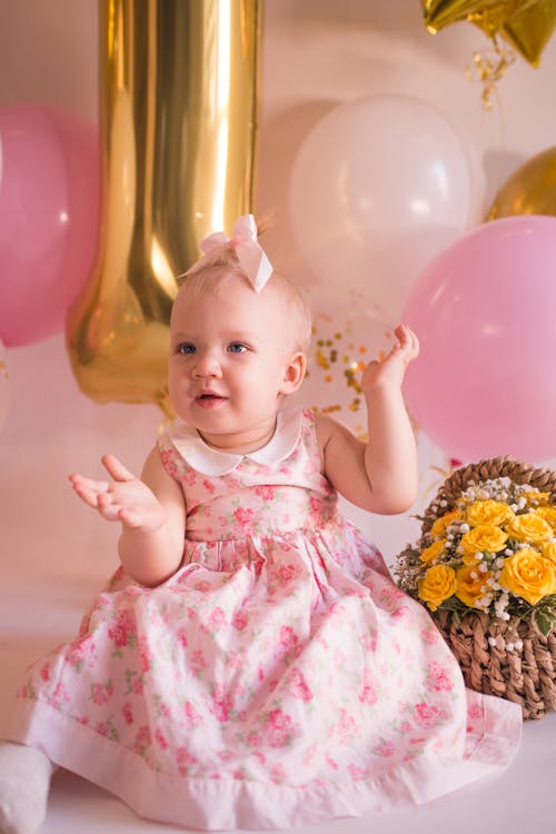 Baby in Pink Floral Dress and Ribbon