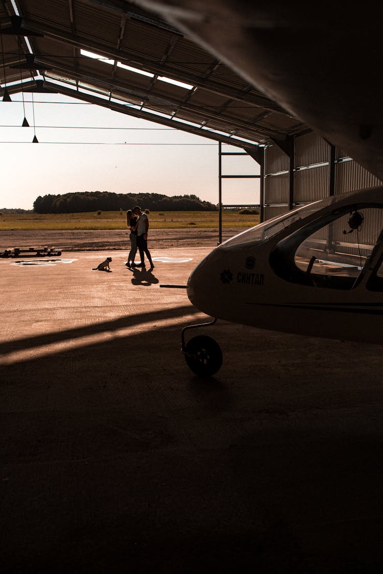 Couple Standing Outside Hangar