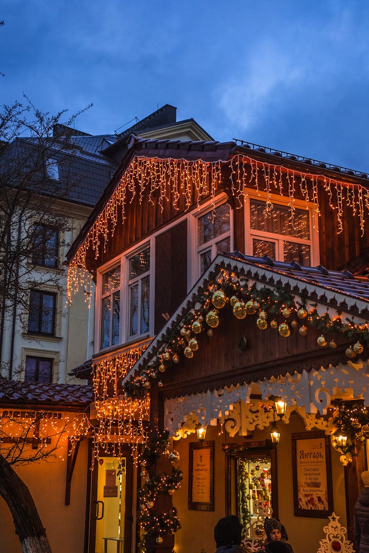 House Decorated With Lights In Evening