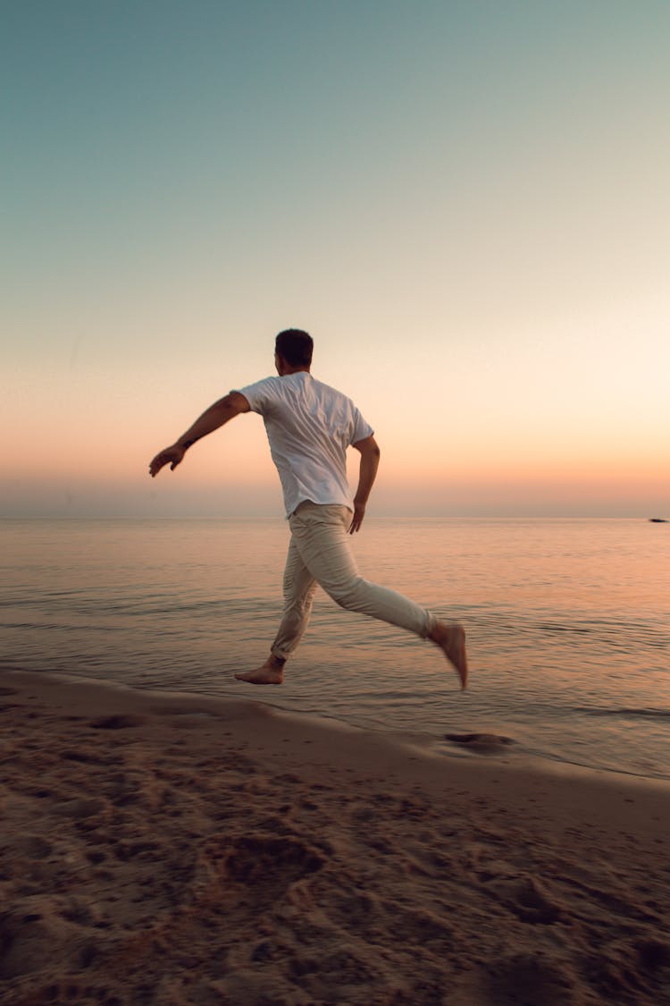 Man Running On Beach