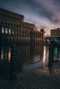Brown Concrete Building Near Body of Water during Night Time