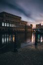 Brown Concrete Building Near Body of Water during Night Time