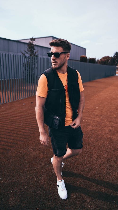 Free A Man in Black Vest and Shorts Wearing Sunglasses Stock Photo