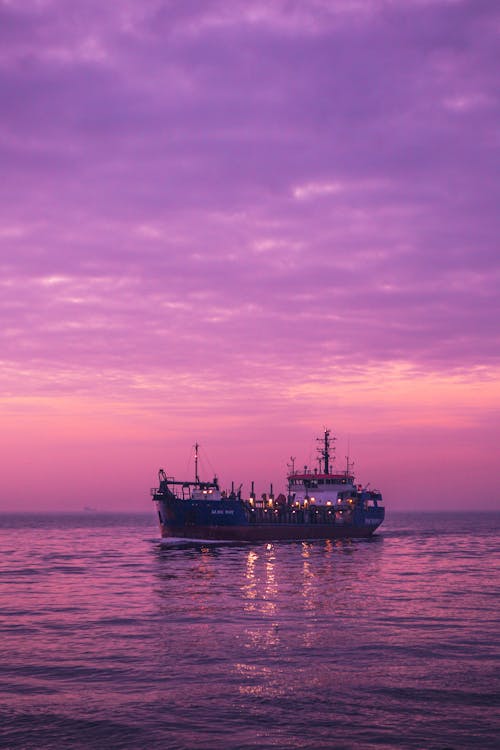 Black Ship on Sea during Sunset