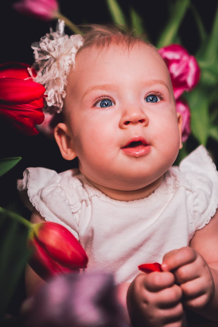 Portrait Of A Little Cute Baby Girl Looking Up In Wonder