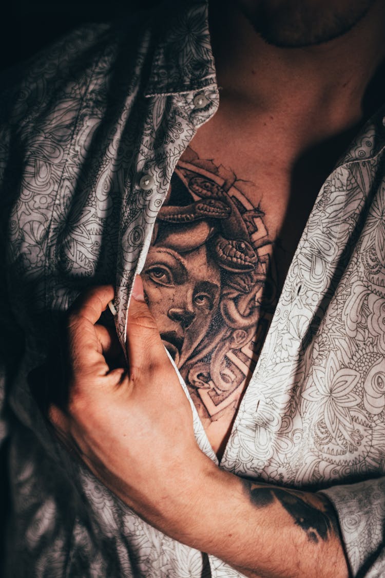 Man Revealing His Chest Tattoo 