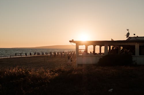 Beach with a Bar on Shore at Sunset