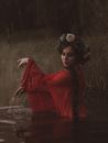 Woman in Red Dress Standing on Water