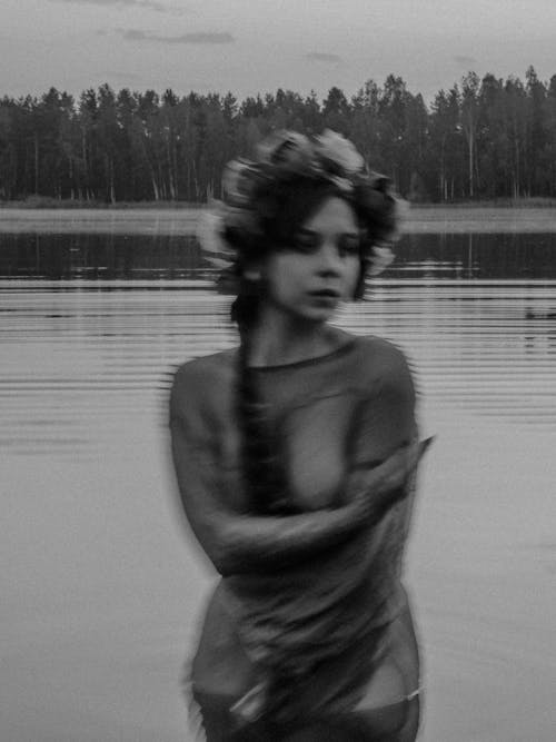 Woman in Long Sleeve Shirt Standing on Water