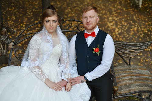 Man in Black Suit Jacket Beside Woman in White Wedding Dress