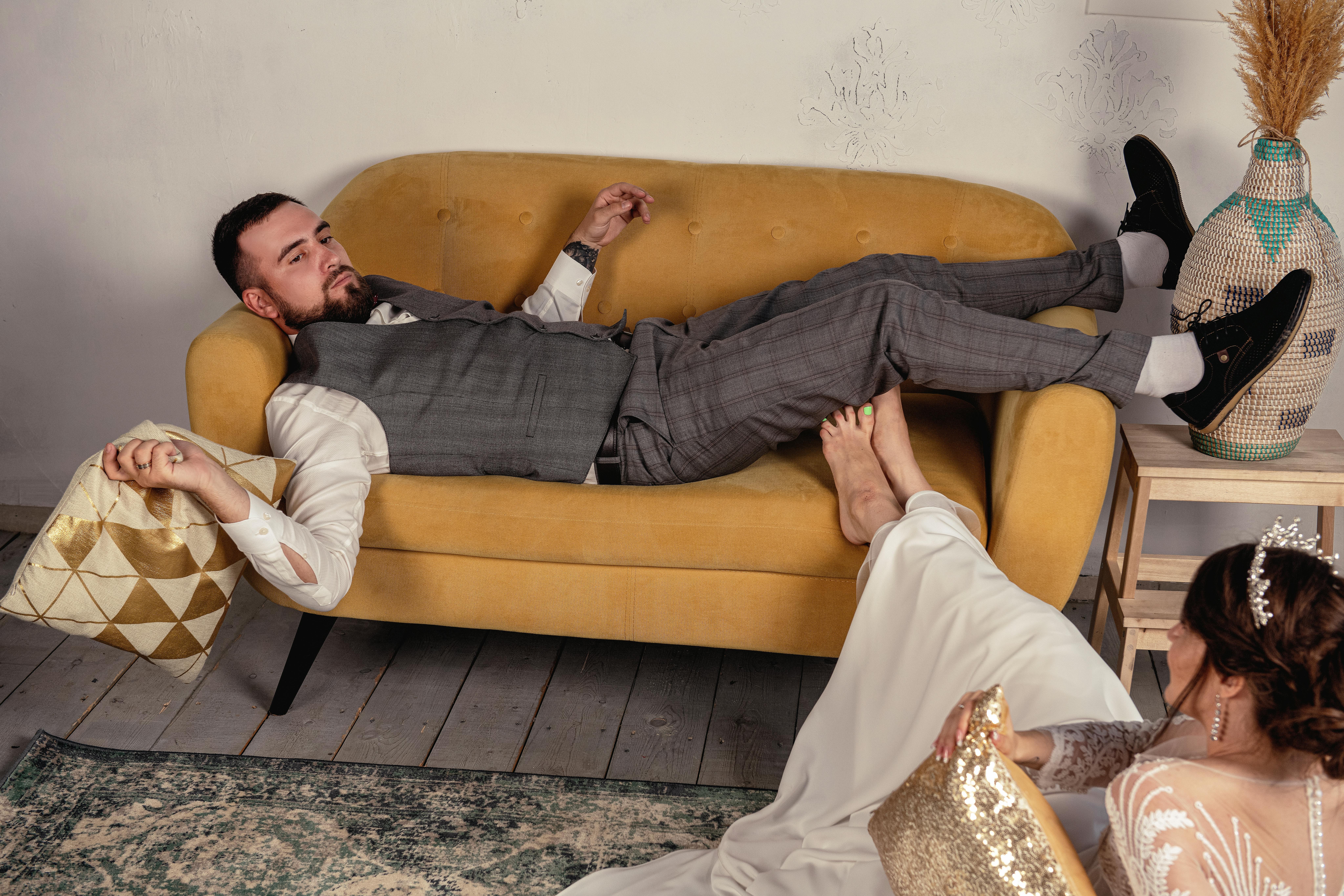 a man lying on brown sofa