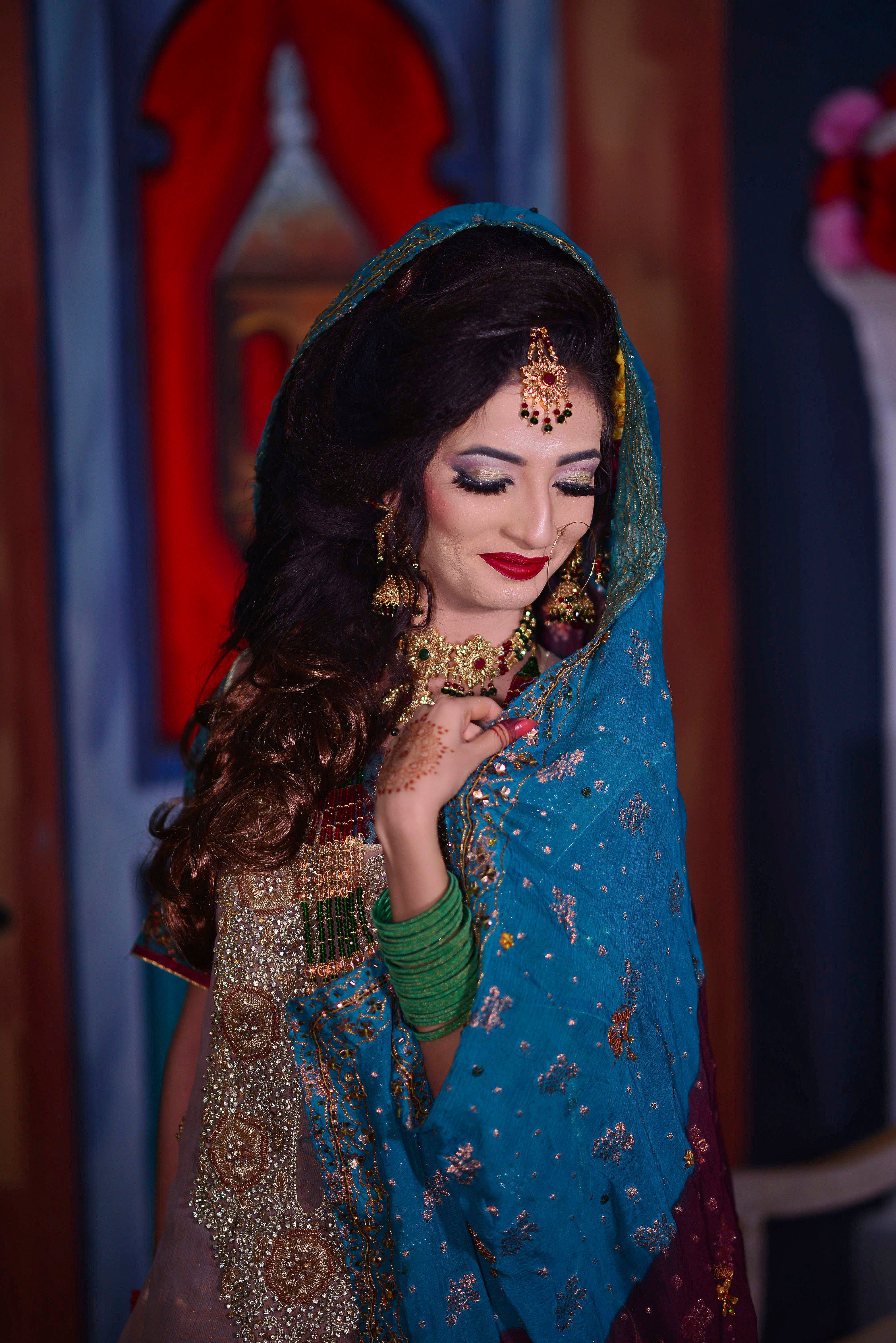 A beautiful South Asian bride in an ornate traditional sari, captured in a stunning portrait.