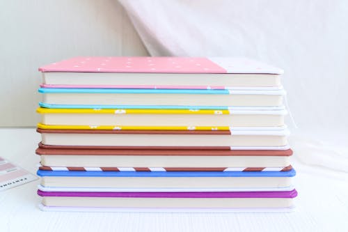 Free Stack of Books on White Surface Stock Photo