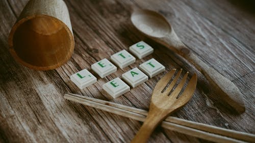 Wooden Fork and Spoon with Cup Near Chopsticks