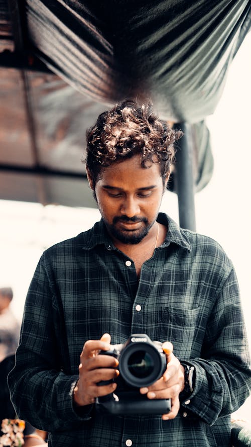 Free Man in Plaid Shirt Holding a Digital Camera Stock Photo