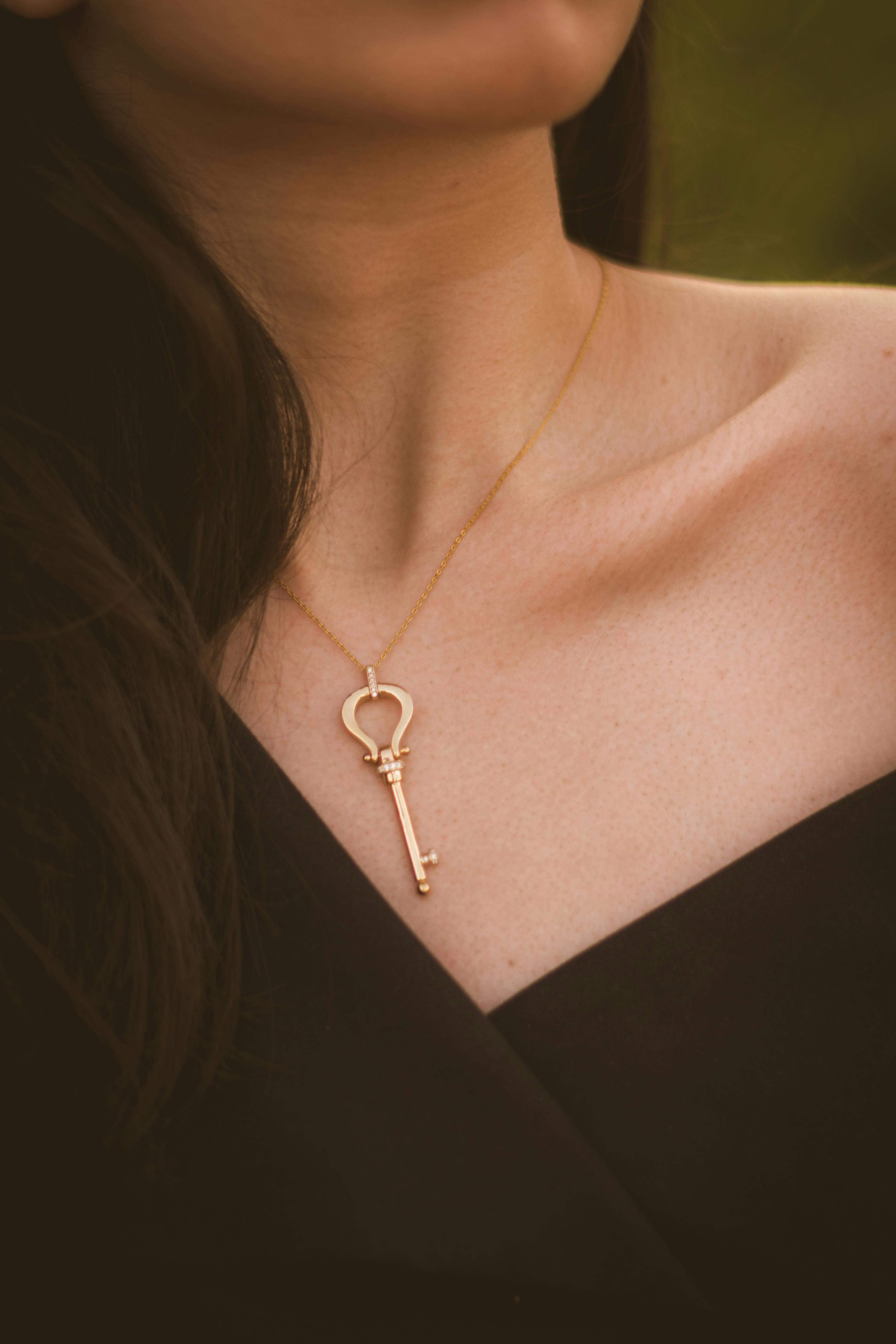 woman wearing gold pendant necklace