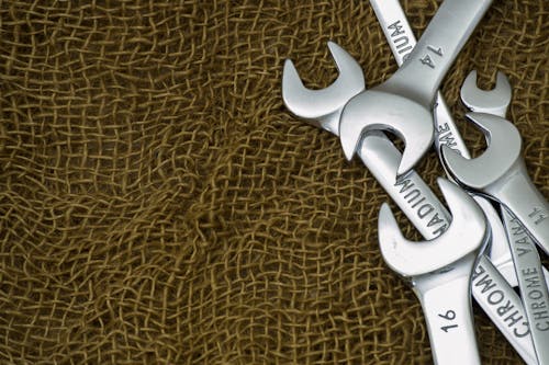 Free Metal Steel Wrenches on Brown Textile Stock Photo