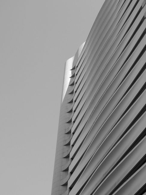 Black and white of upper fragment futuristic multistory house exterior with unusual lined design