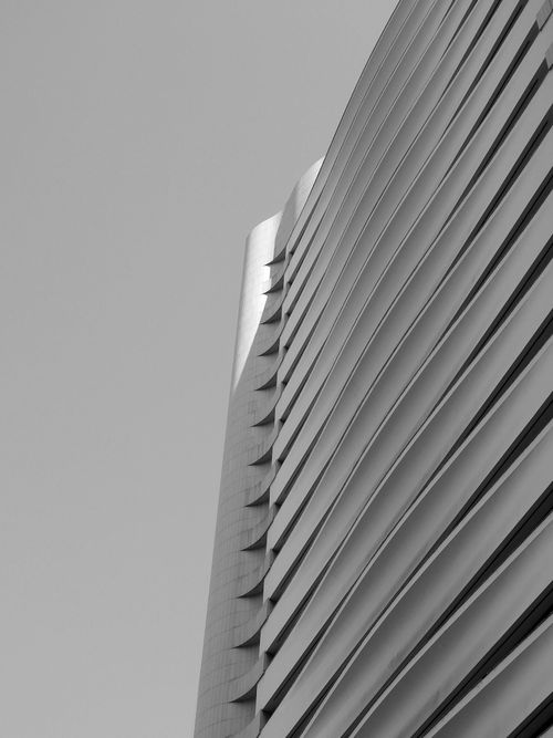 Free Black and white of upper fragment futuristic multistory house exterior with unusual lined design Stock Photo