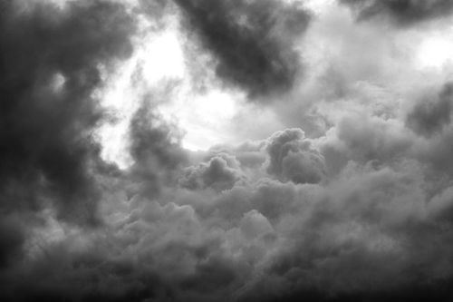 Free Black and white photograph of dramatic cloud formation with light breaking through. Stock Photo