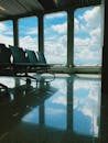 Empty waiting room of modern airport with large windows