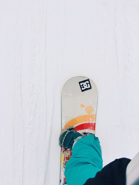 View of a snowboarder on fresh snow, capturing the thrill of winter sports.