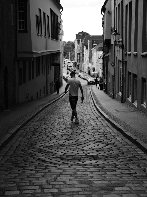 Free A Man Walking on the Street Stock Photo