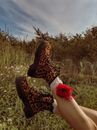 Person Wearing Brown and Black Leopard Print Boots
