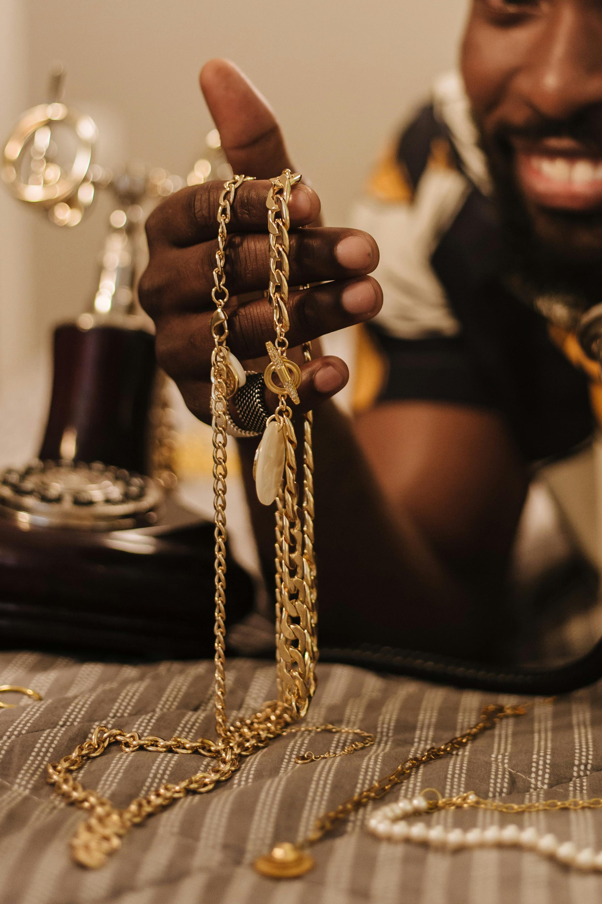 a man holding gold accessories