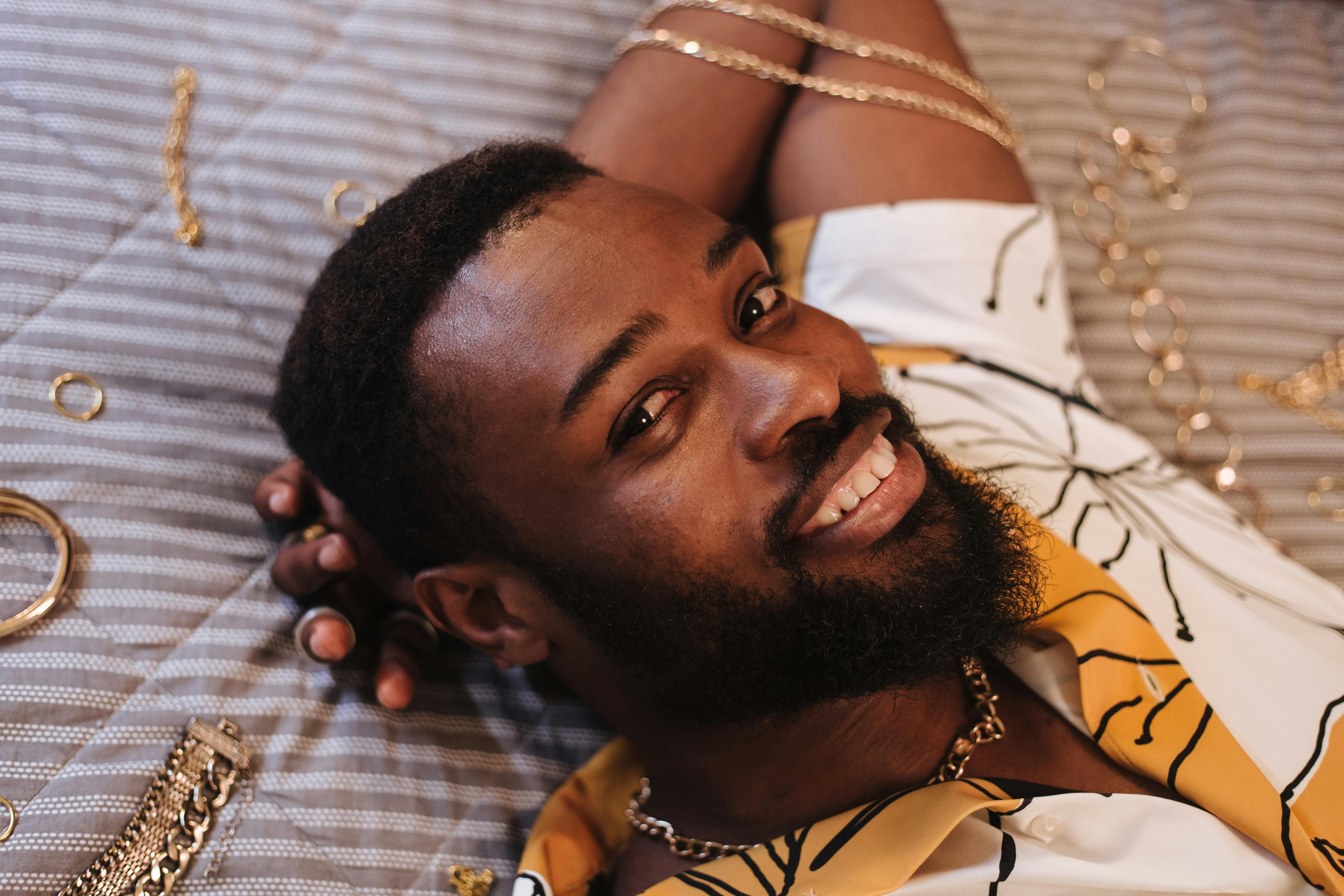 a bearded man lying down