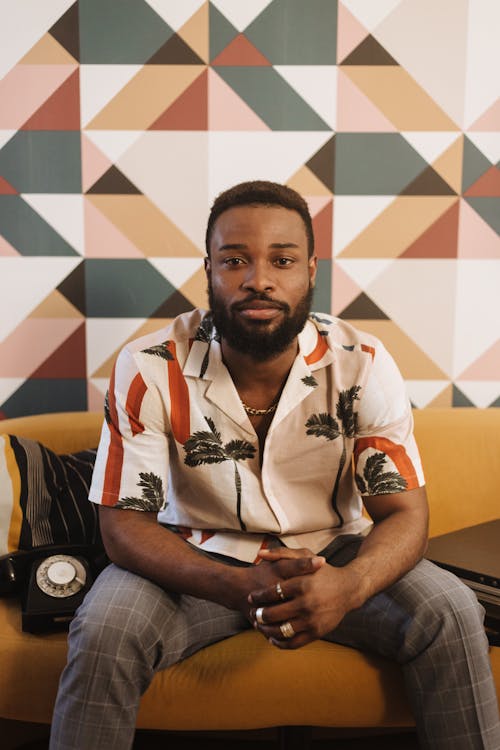 A Man in a Hawaiian Shirt Sitting on a Couch