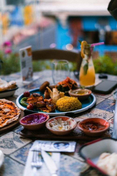 Free A vibrant Mediterranean feast with colorful dishes and refreshing drink on a decorated table. Stock Photo