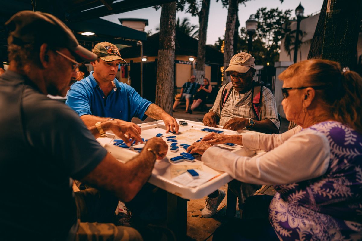 Friends around an outdoor mahjong table