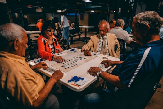 Group of senior adults engaged in an outdoor game of Mahjong in Miami, Florida.