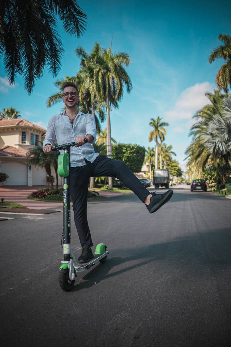 A Man Riding A Scooter 