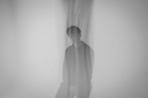 Free A creatively blurred monochrome portrait of a man, capturing an ethereal mood. Stock Photo