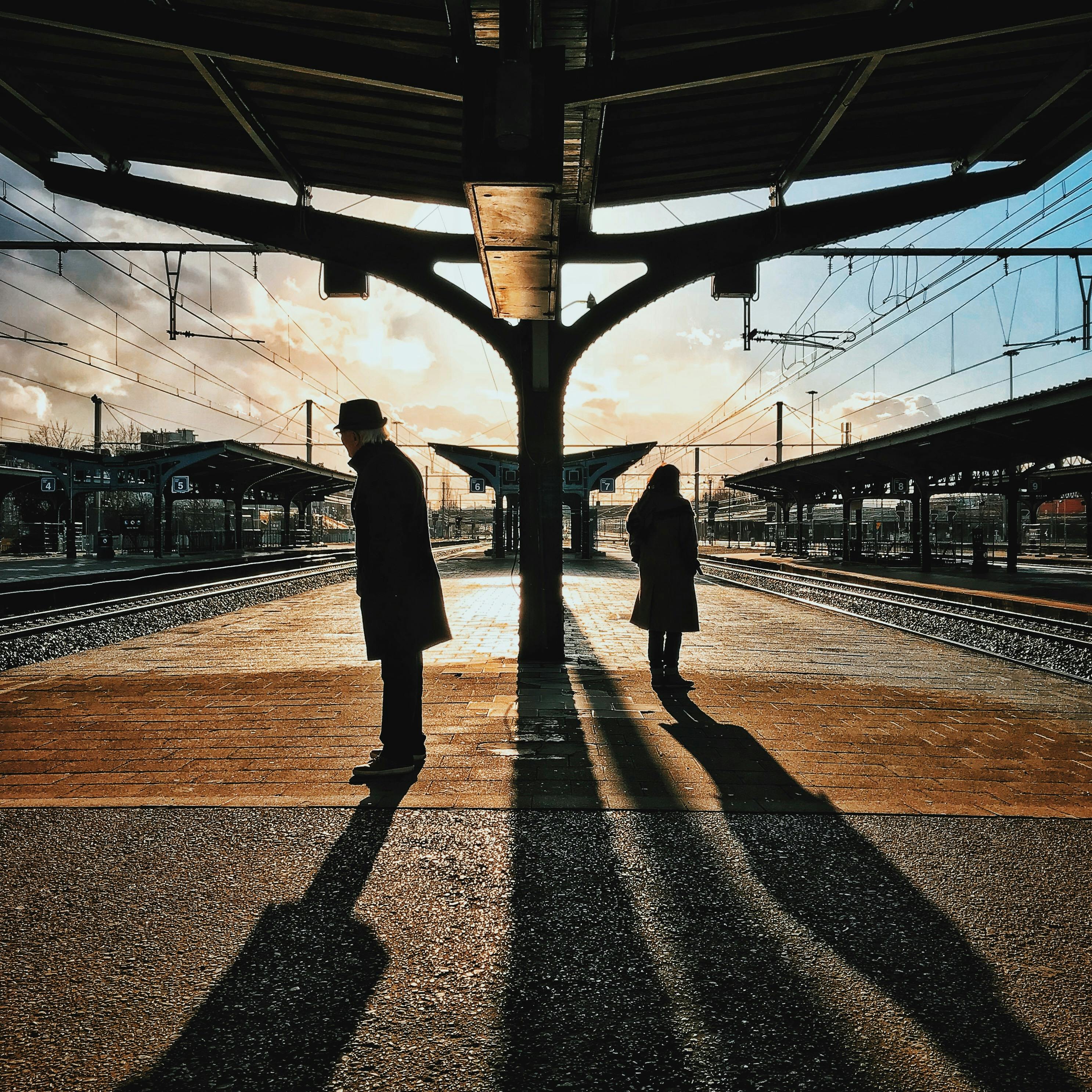 Man And Woman Silhouette Standing On Brown Ground At Daytime Free Stock Photo