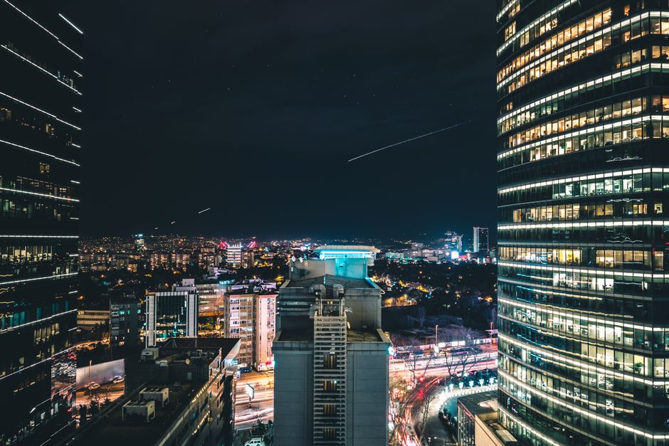 A dynamic cityscape showcasing towering skyscrapers illuminated at night, perfect for urban themes.