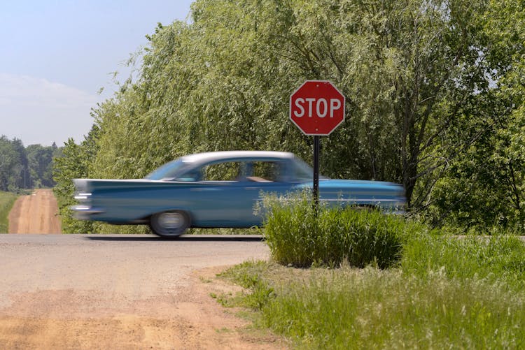 A Blue Classic Car Passing By