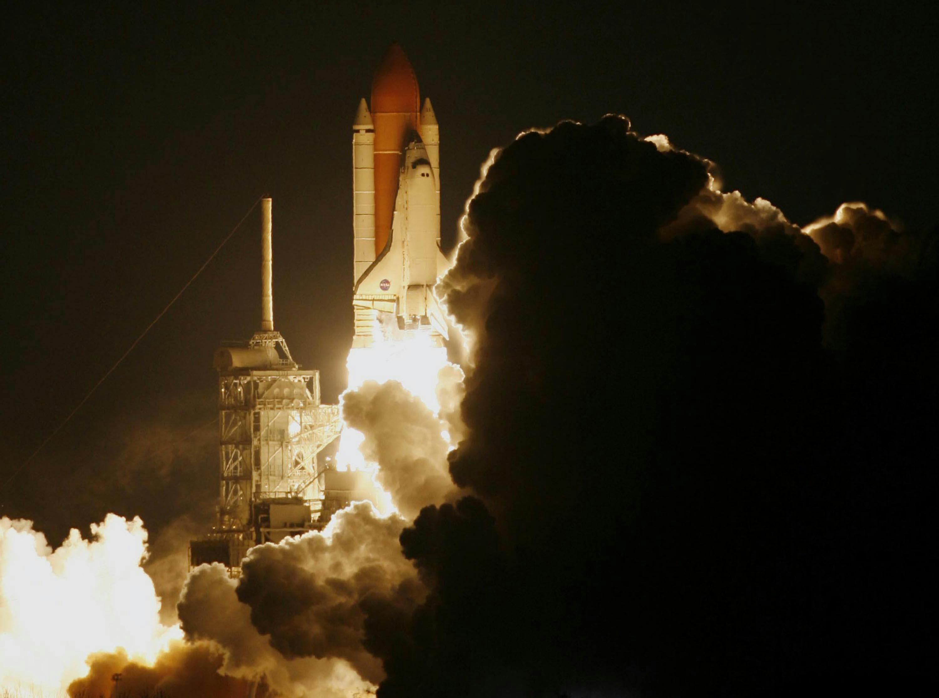 space shuttle blast off at night