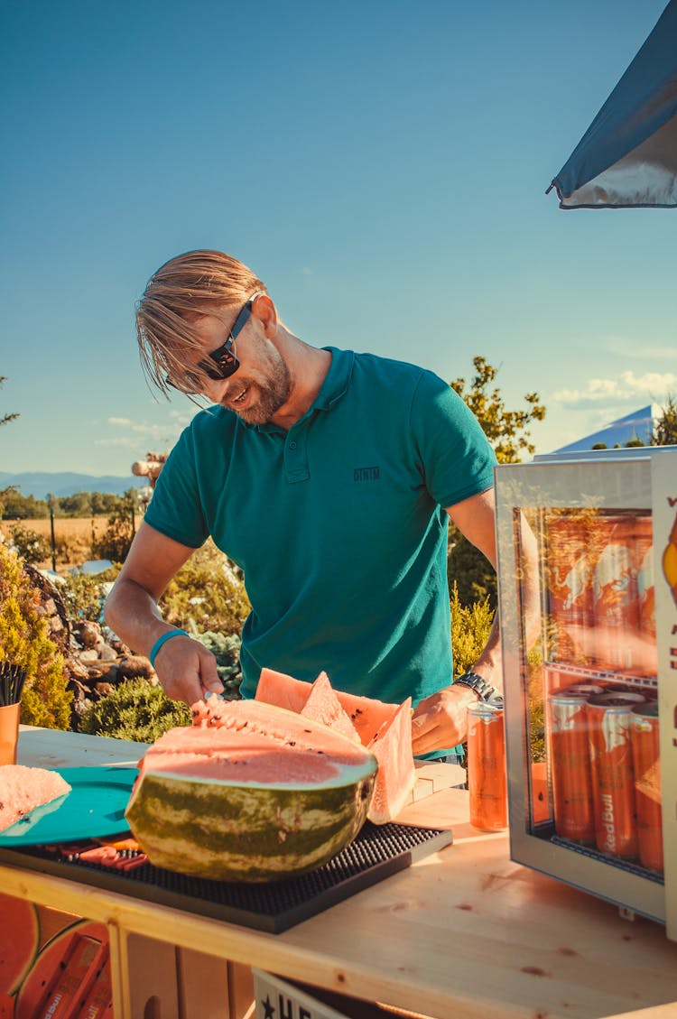 
A Man Slicing A Watermelon