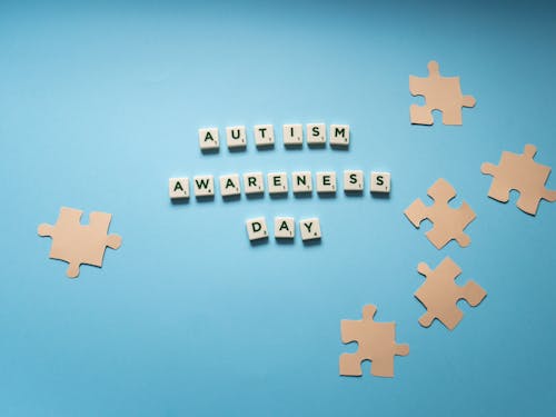 Letter Tiles and Puzzle Cutouts on a Blue Surface
