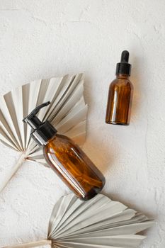 Brown glass bottles on a white surface with a minimalist natural aesthetic.